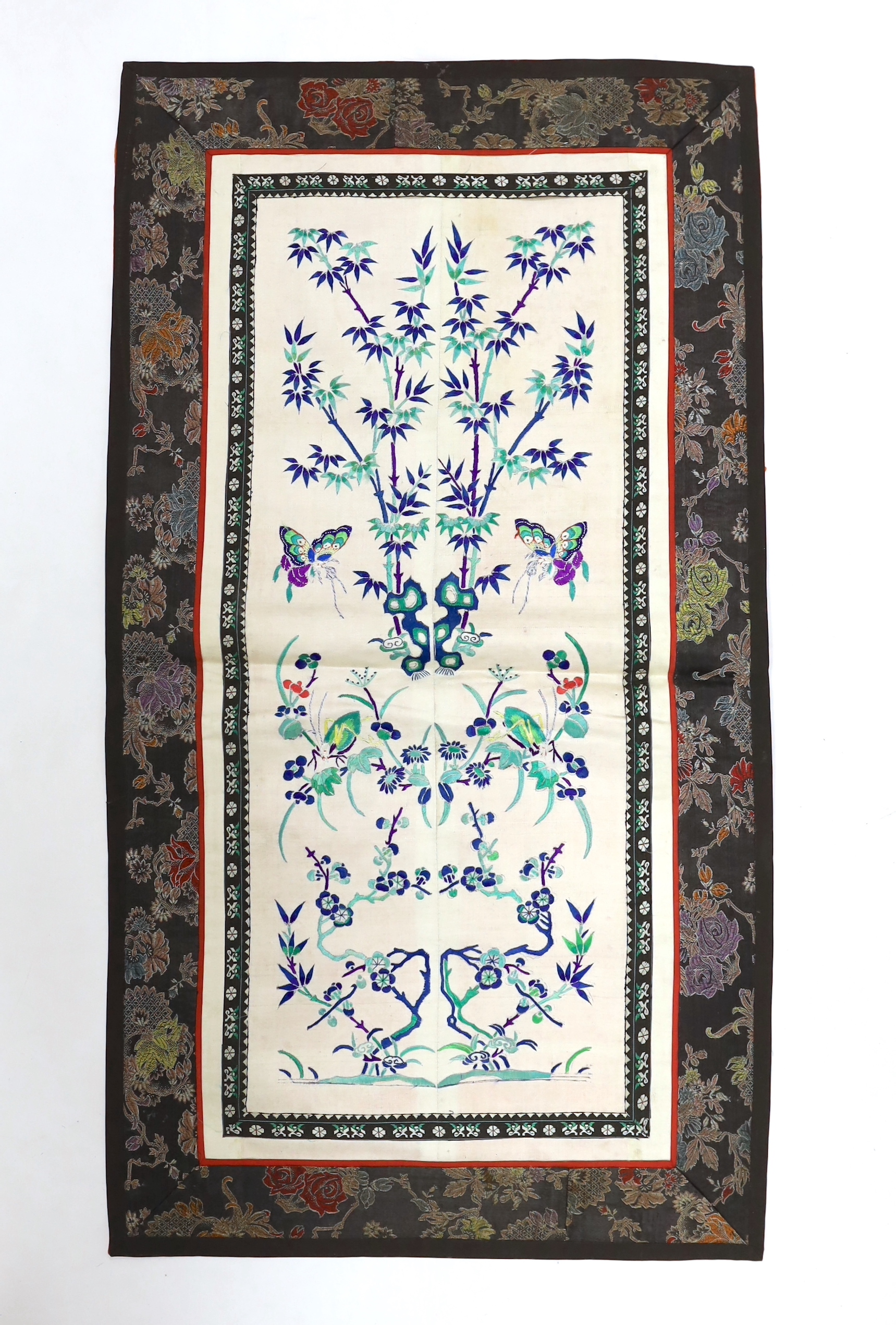 Three pairs of Chinese embroidered sleeve bands, polychrome silk designs on cream silk background, together with a single sleeve band, all bordered with damask silk, longest panel including border 66cm x 35cm wide